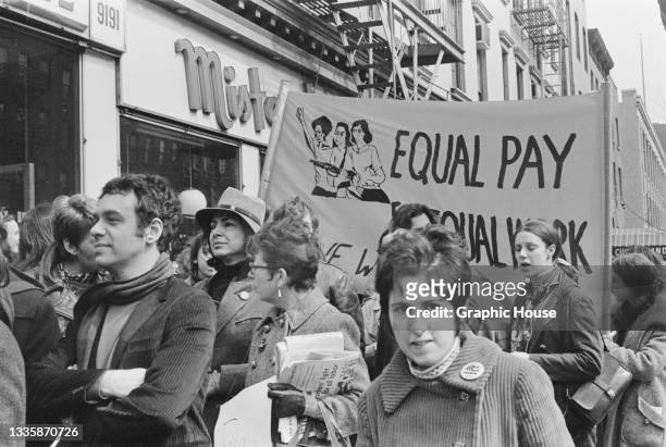 Protestors carrying a banner reading 'Equal pay for equal work' during a mass demonstration against New York State abortion laws, in the Manhattan...