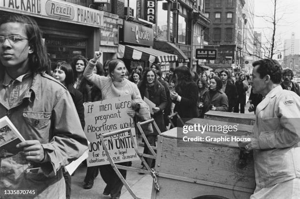 Protestor carrying a placard reading 'If man were pregnant abortions would be legal, women united for free and legal abortions on our demand' during...