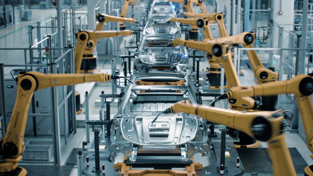 Car Factory 3D Concept: Automated Robot Arm Assembly Line Manufacturing High-Tech Green Energy Electric Vehicles. Automatic Construction, Welding Industrial Production Conveyor. Front View Time-Lapse