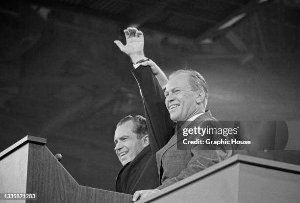 American politician Richard Nixon and American politician Gerald Ford wave from the lectern on the final day of the 1968 Republican National...