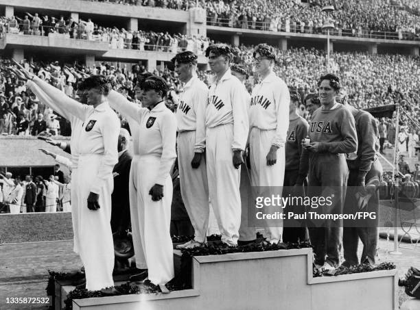 The Germany team giving the Nazi salute, the Great Britain team , and USA team on the podium after the Men's 4x400 metres relay event of the 1936...