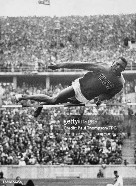 American athlete Dave Albritton clears the bar as he competes in the High Jump event of the 1936 Summer Olympics at the Olympiastadion in Berlin,...