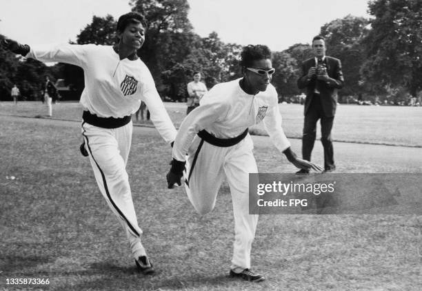 American athlete Vivian Brown and American athlete Wilma Rudolph , both wearing USA tracksuits, training for the relay, in Hyde Park, London,...