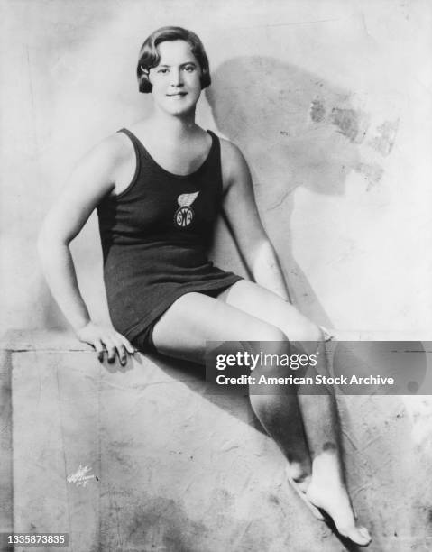 American swimmer Gertrude Ederle wearing a swimsuit with a 'Women's Swimming Association' patch on the chest, location unspecified, circa 1930.