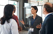 Shot of a group of businesspeople networking at a conference