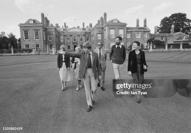 Viscount Althorp, Charles Spencer, leading a group of unspecified tourists around the grounds of the Spencer family home, Althorp, located between...