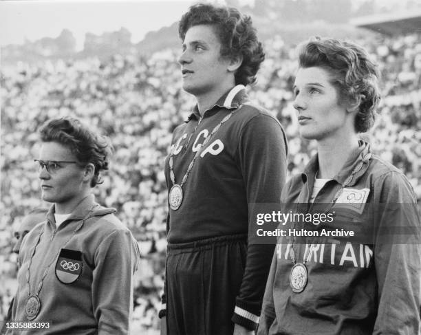 German athlete Gisela Birkemeyer, Soviet-born Ukrainian athlete Irina Press , and British athlete Carole Quinton on the winner's podium after the...