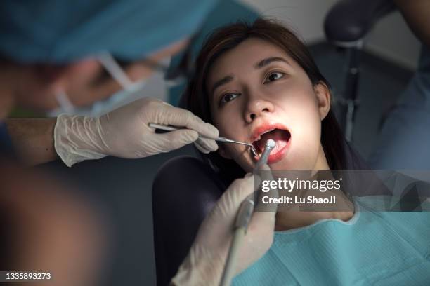 the young woman examined her teeth at the dentist - tooth ache stock pictures, royalty-free photos & images