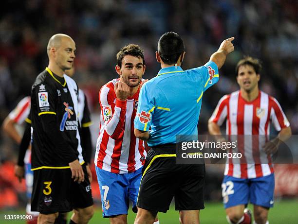 Atletico Madrid's forward Adrian Lopez Alvarez gestures during the Spanish league football match between Atletico de Madrid and Levante at the...