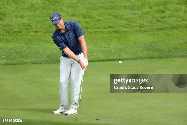 Adam Schenk of the United States chips to the first green during the final round of THE NORTHERN TRUST, the first event of the FedExCup Playoffs, at...