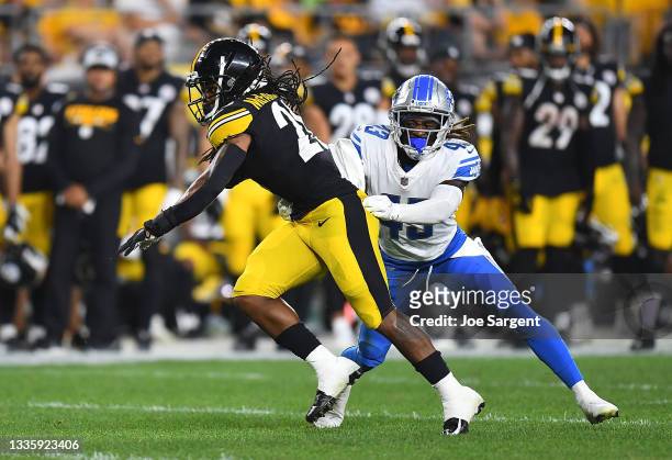 Anthony McFarland of the Pittsburgh Steelers avoids a tackle by Nickell Robey-Coleman of the Detroit Lions at Heinz Field on August 21, 2021 in...