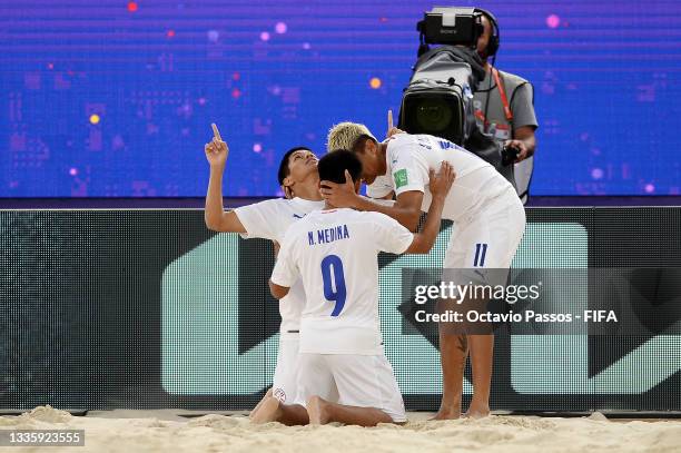 Milciades Medina of Paraguay celebrates with Nestor Medina and Sergio Villaverde after scoring their side's sixth goal during the FIFA Beach Soccer...
