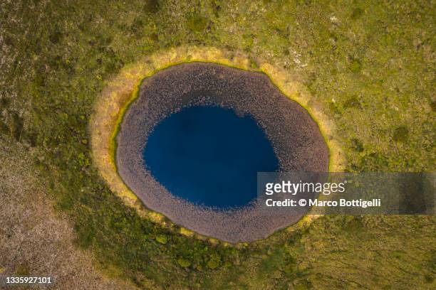 eye-shaped volcano crater with round lake. aerial view. azores, portugal - volcanic crater stockfoto's en -beelden