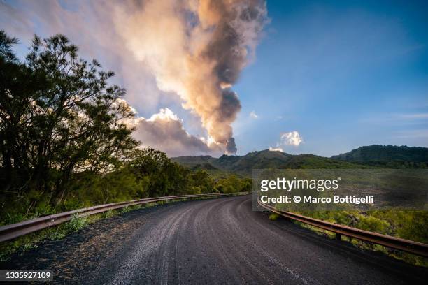 road full of lapilli leading to erupting volcano - etna stock pictures, royalty-free photos & images