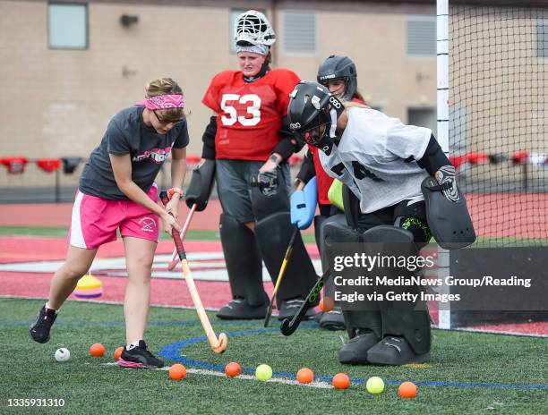 West Lawn, PA Goalie coach Sarah Dobroskey does a drill with goalie Olivia Baxewanis. During a Wilson High School field hockey team practice at John...