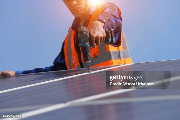 engineers checking and repairing solar panel at generating power of solar power plant. - solar system stock-fotos und bilder