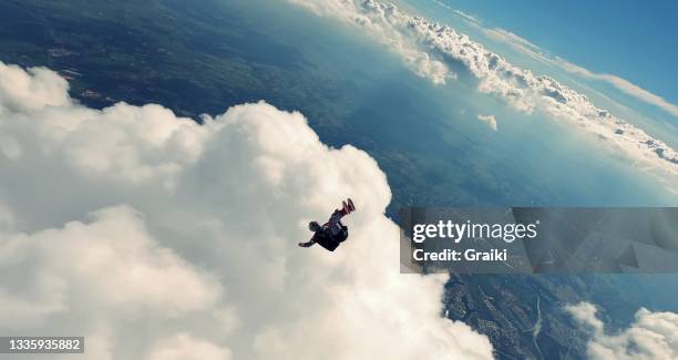 skydiver falling in back position - skydiving stock pictures, royalty-free photos & images