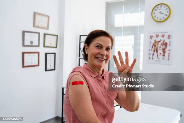 senior adult  woman after her  fourth dose of a covid-19 vaccination - dose bildbanksfoton och bilder