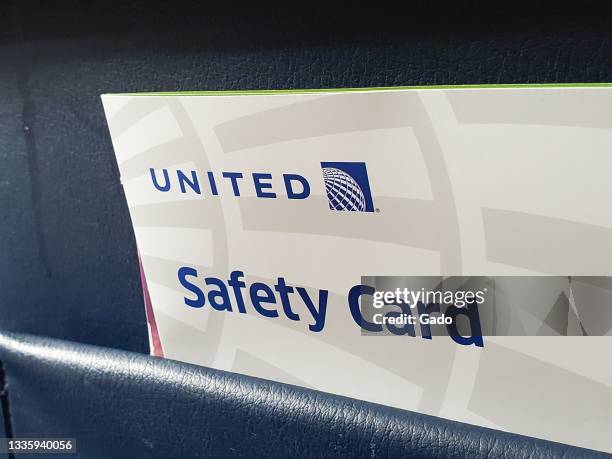 Close-up of United Airlines safety card in tray table pouch, July 26, 2021. Photo courtesy Sftm.