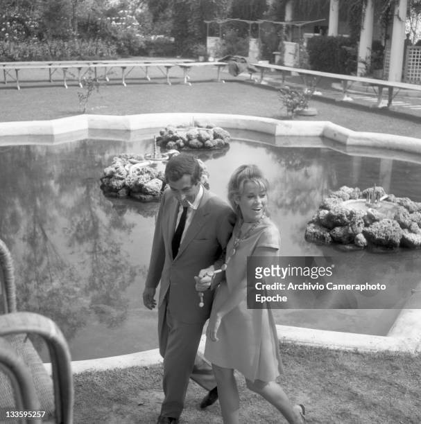 American actress Jane Fonda with Roger Vadim walking in a garden, Lido 1967.