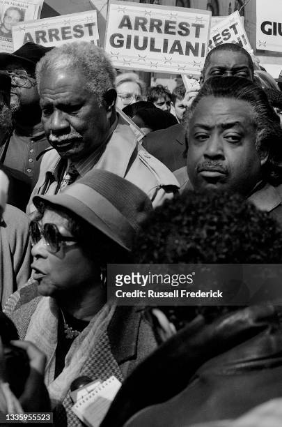 Notable community activists and actors Ruby Dee and Ossie Davis stand with Reverend Al Sharpton as they protest against police brutality for the...