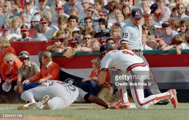 California Angels Bobby Grich has a close tag at 1st base with Boston Red Sox Don Baylor during pick-off attempt during ALCS, October 12, 1986 in...
