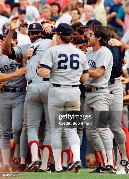 Boston Red Sox Dave Henderson is mobbed by Wade Boggs , Rich Geldman , Dwight Evans and teammates after home run victory in Game 5 during ALCS,...