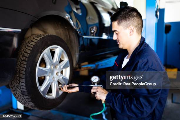 mechanic inflating tire hand holding gauge pressure for checking and filling air in car tire. automobile concept. - nitrogen stock pictures, royalty-free photos & images