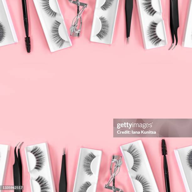 various tools for eye lash extensions on trendy pastel pink background. banner. eyelash curler, tweezers. makeup accessories. cosmetics. fake eyelashes. copy space. - tweezer stock pictures, royalty-free photos & images