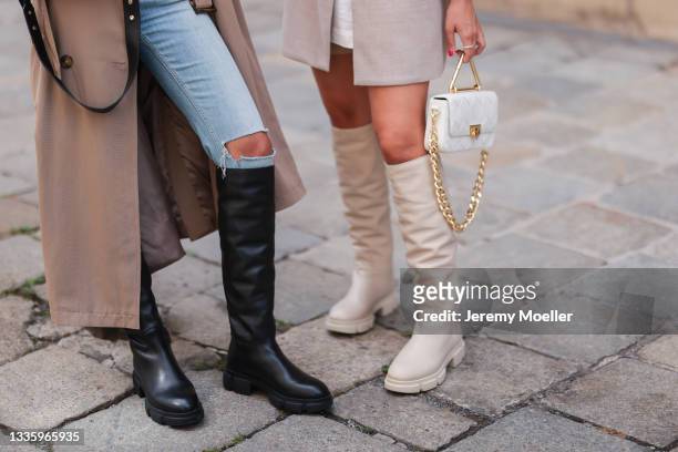 Sonia Dhillon wearing olive trenchcoat, blue destroyed denim and black Copenhagen knee-high boots and Christina Biluca wearing white shirt, beige...