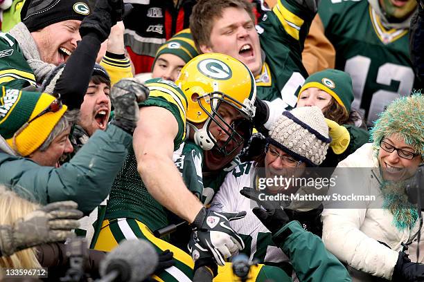 Jordy Nelson of the Green Bay Packers leaps into the bleachers after scoring a touchdown against the Tampa Bay Buccaneers at Lambeau Field on...