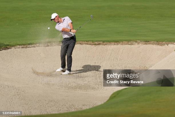 Rory McIlroy of Northern Ireland plays a shot from a greenside bunker on the eighth hole during the final round of THE NORTHERN TRUST, the first...