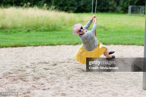 senior woman on swing at playground - only senior women stock pictures, royalty-free photos & images