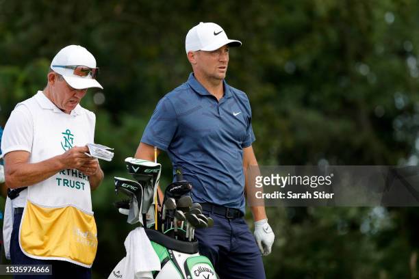 Alex Noren of Sweden and caddie David McNeilly wait on the 16th tee during the final round of THE NORTHERN TRUST, the first event of the FedExCup...