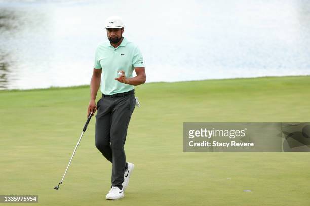 Tony Finau of the United States waves after making an eagle on the 13th green during the final round of THE NORTHERN TRUST, the first event of the...