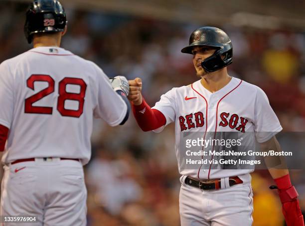 North andover, MA Boston Red Sox 2nd base Enrique Hernandez is congratulated on scoring by Boston Red Sox left fielder J.D. Martinez on a single by...