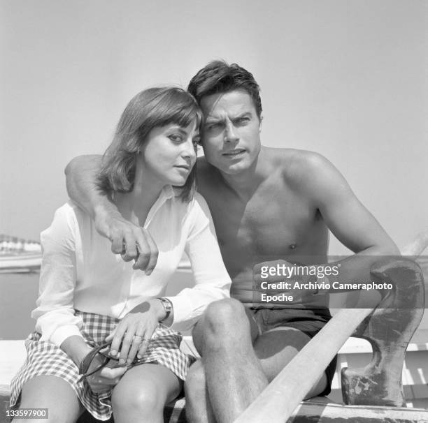 French actor Jean Sorel with his wife Anna Maria Ferrero, sitting on a boat on the seashore, Lido, Venice, 1967.