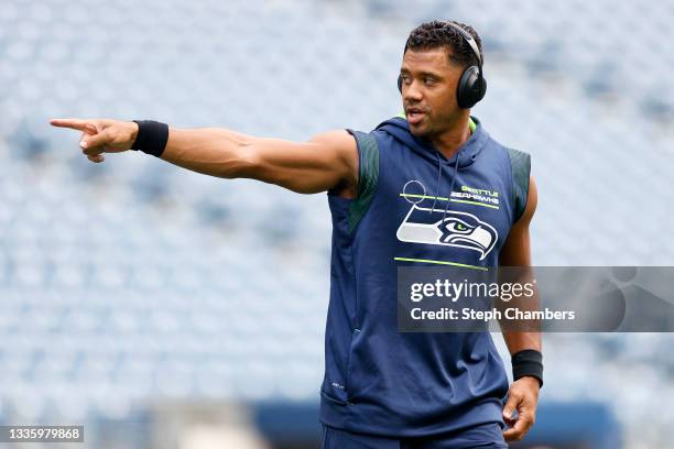 Quarterback Russell Wilson of the Seattle Seahawks warms up before an NFL preseason game against the Denver Broncos at Lumen Field on August 21, 2021...