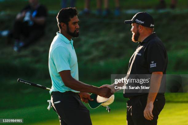 Tony Finau of the United States and Shane Lowry of Ireland shake hands on the 18th green during the final round of THE NORTHERN TRUST, the first...