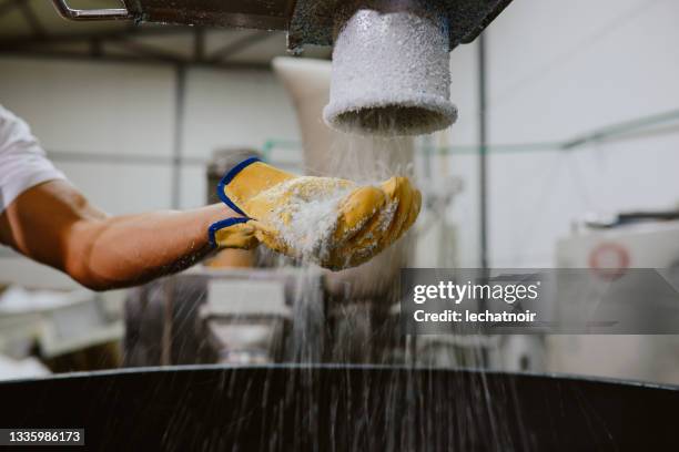 man inspecting pellets made of biodegradable materials - biodegradable plastic stock pictures, royalty-free photos & images