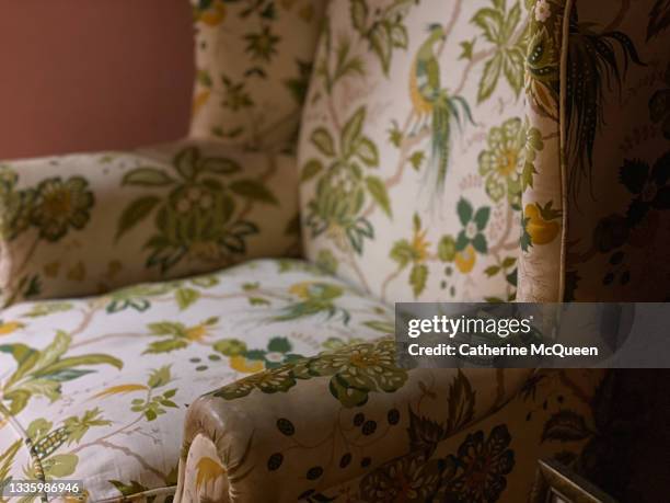 empty wingback chair with soft botanical print - upholstered furniture stock pictures, royalty-free photos & images