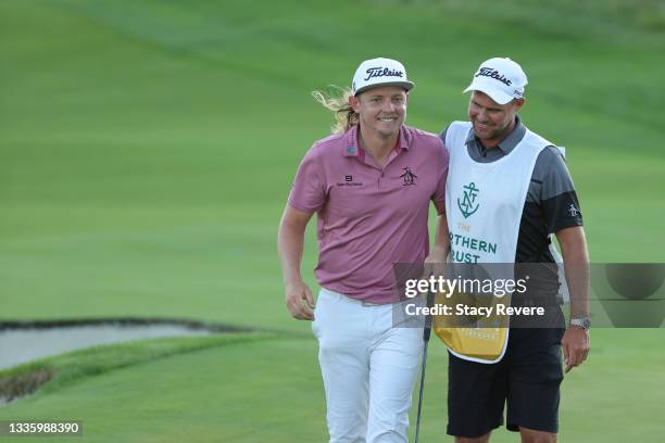 Cameron Smith of Australia smiles with caddie Sam Pinfold on the first-playoff 18th hole during the final round of THE NORTHERN TRUST, the first...