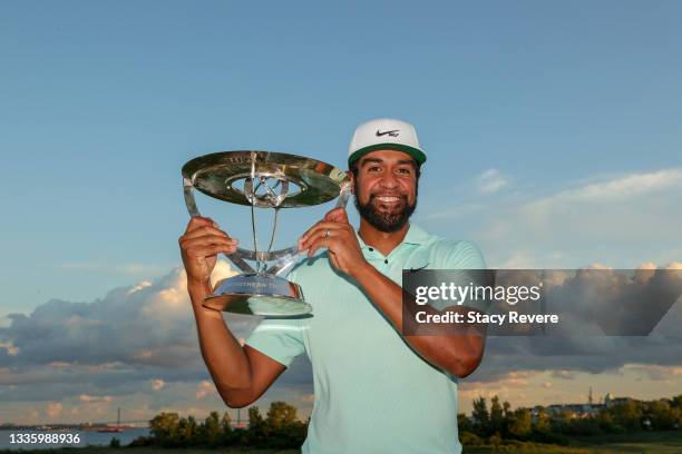 Tony Finau of the United States celebrates with the trophy after winning in a playoff during the final round of THE NORTHERN TRUST, the first event...