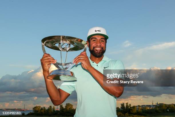 Tony Finau of the United States celebrates with the trophy after winning in a playoff during the final round of THE NORTHERN TRUST, the first event...