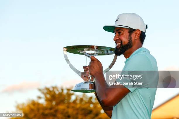 Tony Finau of the United States celebrates with the trophy after winning in a playoff during the final round of THE NORTHERN TRUST, the first event...