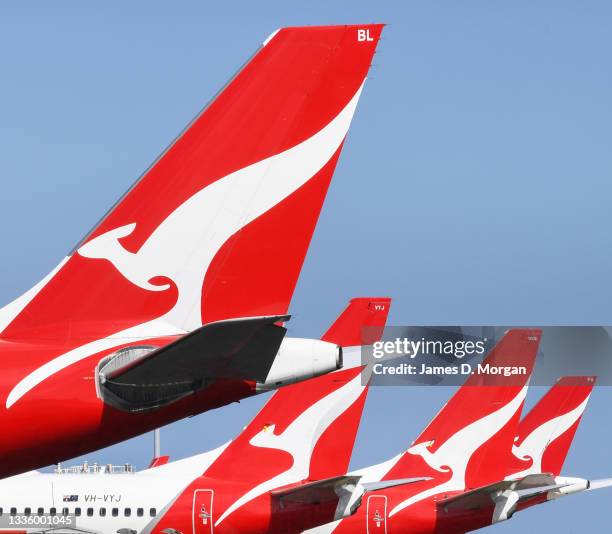 The tail fins of Qantas aircraft parked at Sydney's Kingsford Smith International Airport on August 18, 2021 in Sydney, Australia. Qantas Group has...