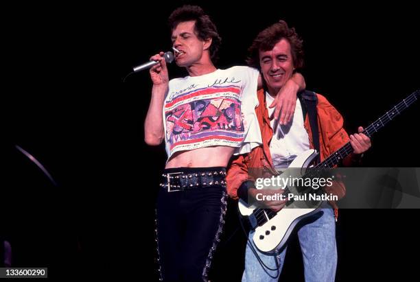 British musicians Mick Jagger and Bill Wyman of the Rolling Stones performs on stage during the band's 'Steel Wheels' tour, late 1989.