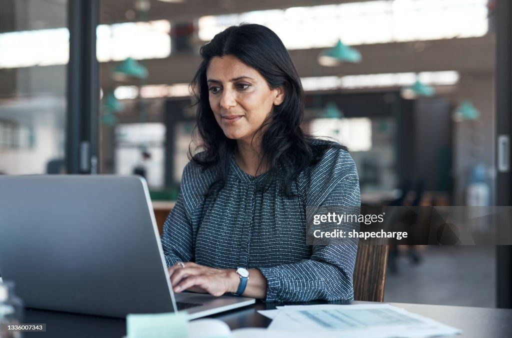 Shot of a mature businesswoman using a laptop in a modern office