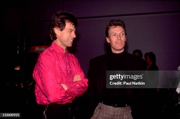 Backstage at the Rolling Stones' 'Steel Wheels' tour, British musician Mick Jagger of the Rolling Stones poses with musician Steve Winwood, late 1989.