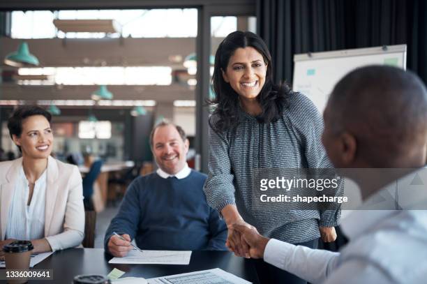 shot of a businesswoman and businessman shaking hands during a meeting in a modern office - recruitment stock pictures, royalty-free photos & images